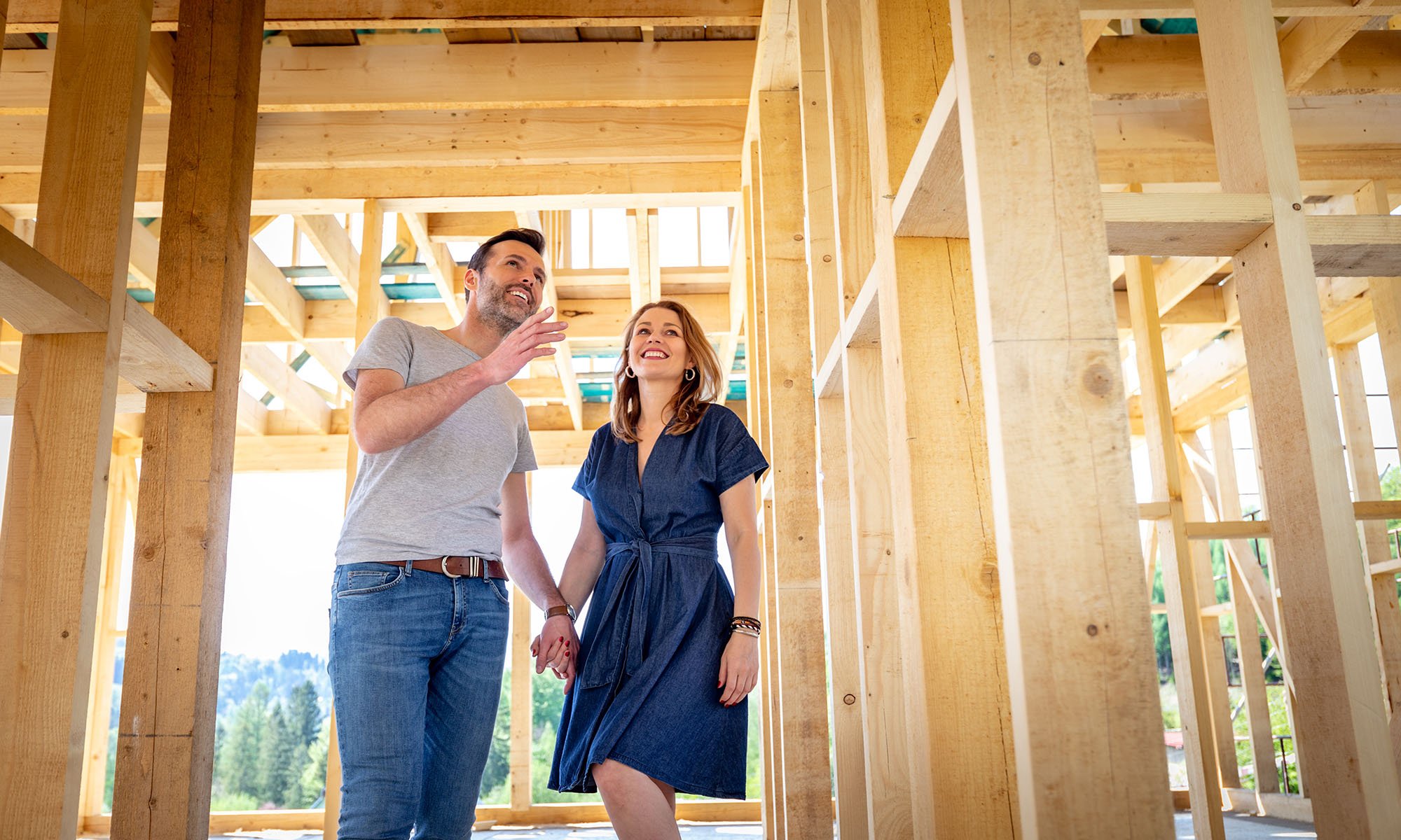 couple walking though house under construction